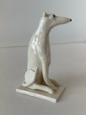 Sitting White Dog On A Porcelain White base