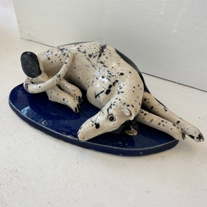 Curled up Spotty Dog on Blue Base